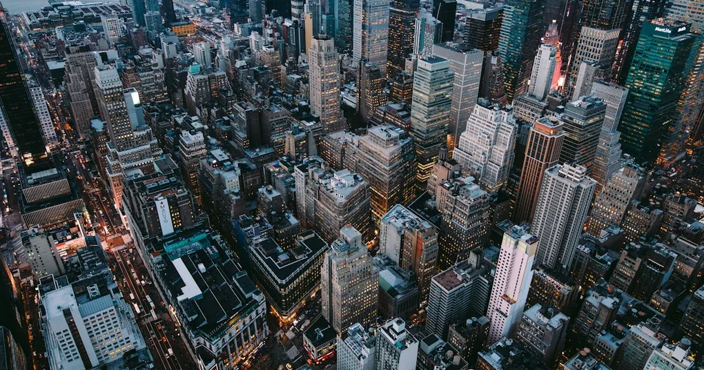 A split-screen image of an anime character and a Marvel superhero, with a cityscape in the background, representing the fusion of Eastern and Western design principles