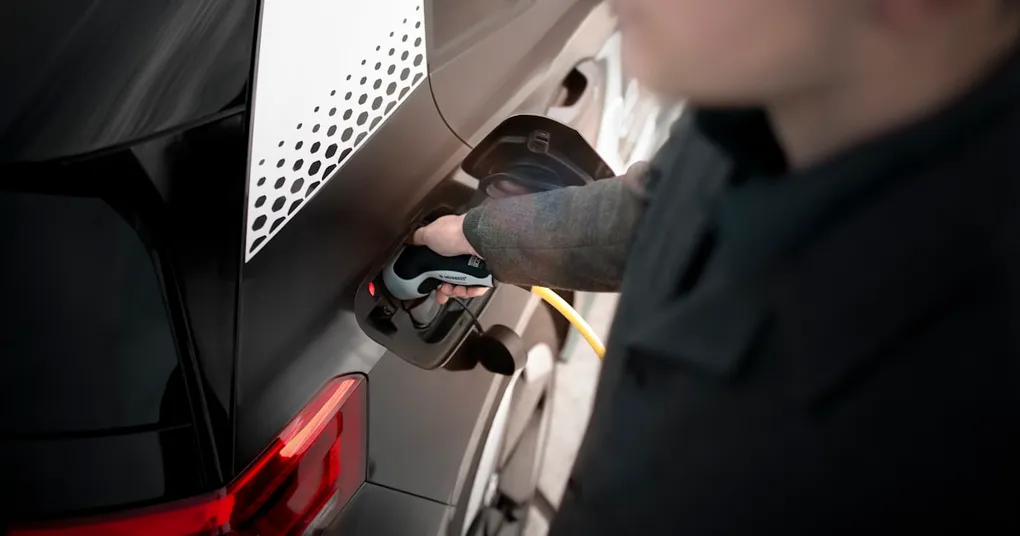 A high-speed electric car on a racing track, leaving traditional gas-powered cars in the dust