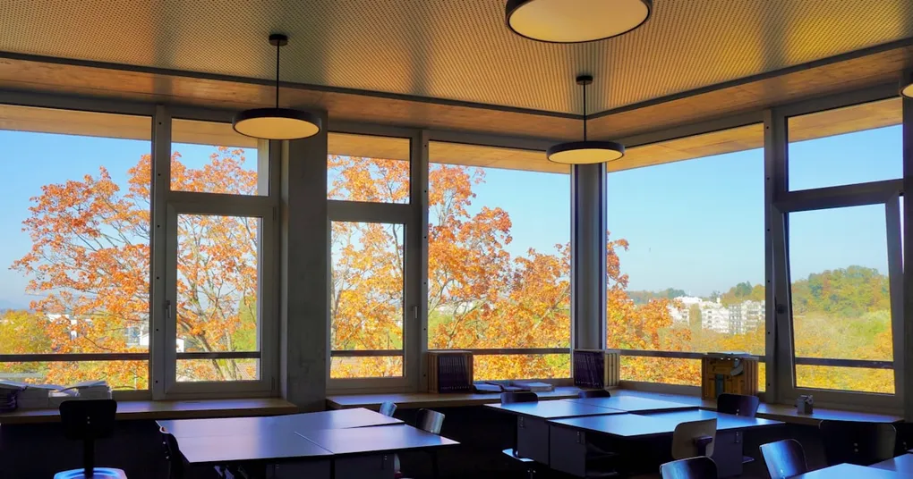 A photo of a classroom with students using books instead of laptops